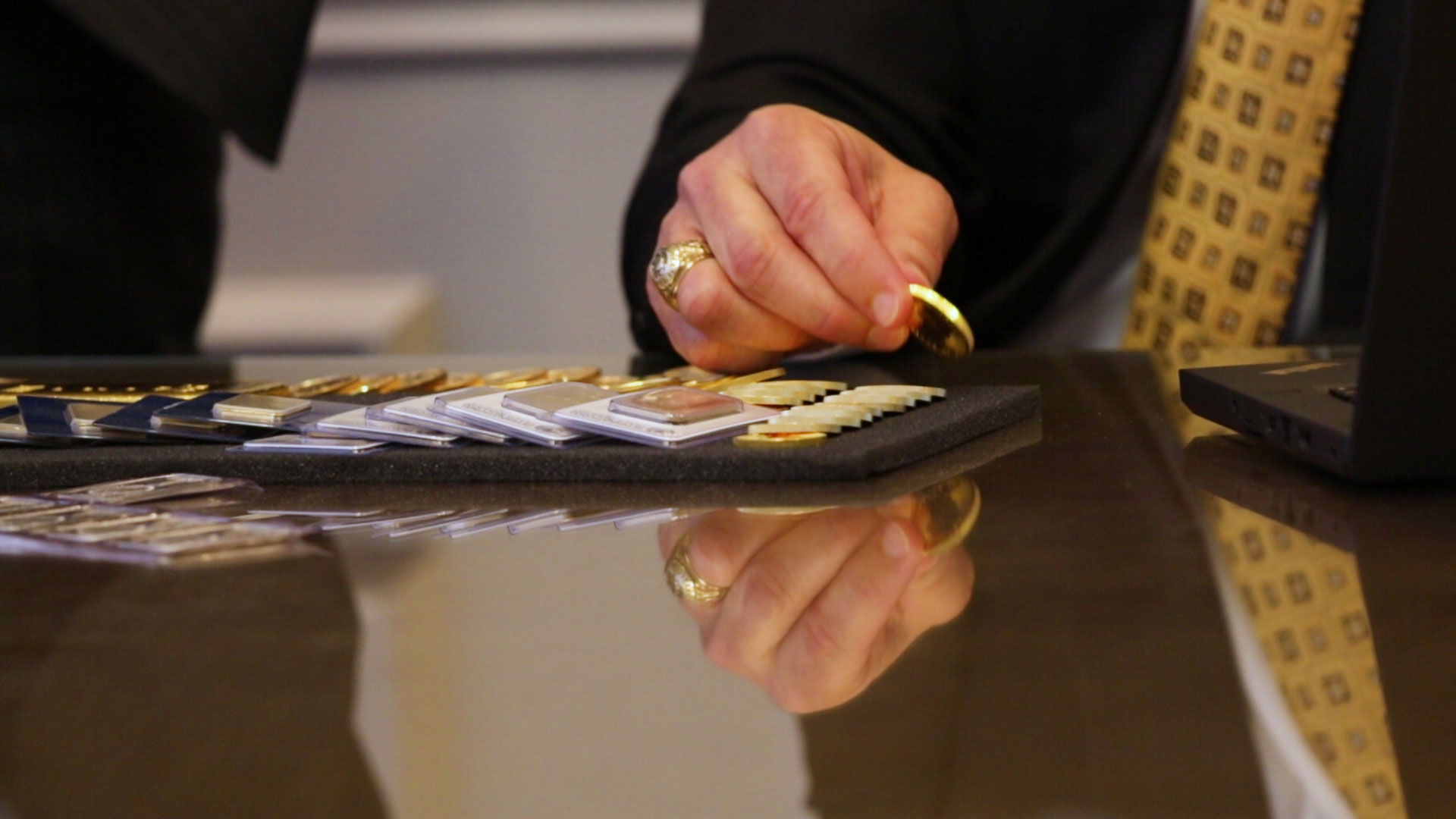 download Comptroller Glenn Hegar examining a gold coin