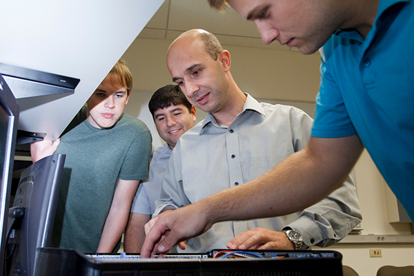 Photo of Dr. Kamil Sarac leading his students